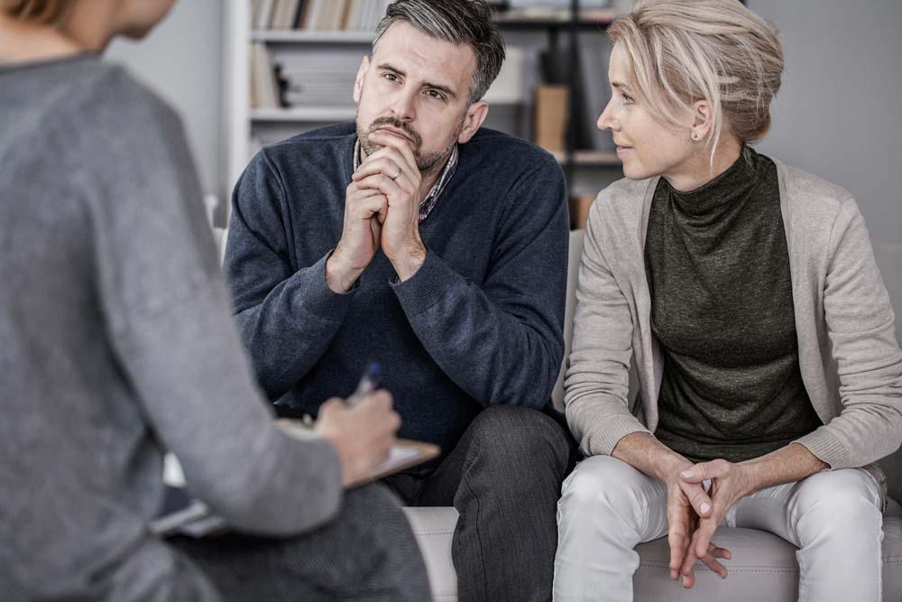 Wife and husband during marriage therapy with counselor | Adobe Stock #310944954 Photographee.eu